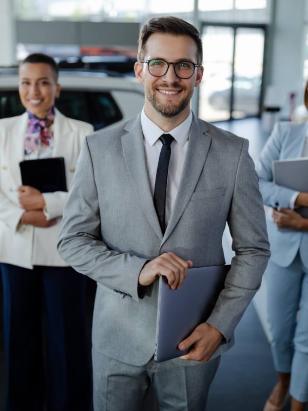 salesteam-in-dealership-three-beautiful-consultants-or-managers-in-elegant-suit-looking-on-camera-.jpg